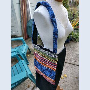 Purse: ethnic/tribal-inspired woven, floral + geometric, open top. Unbranded.